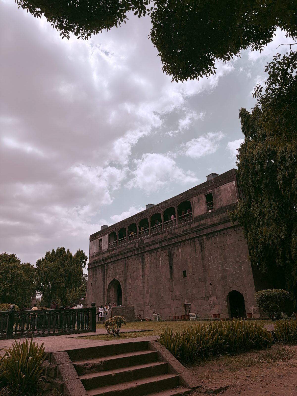 A heritage fort under a dramatic sky