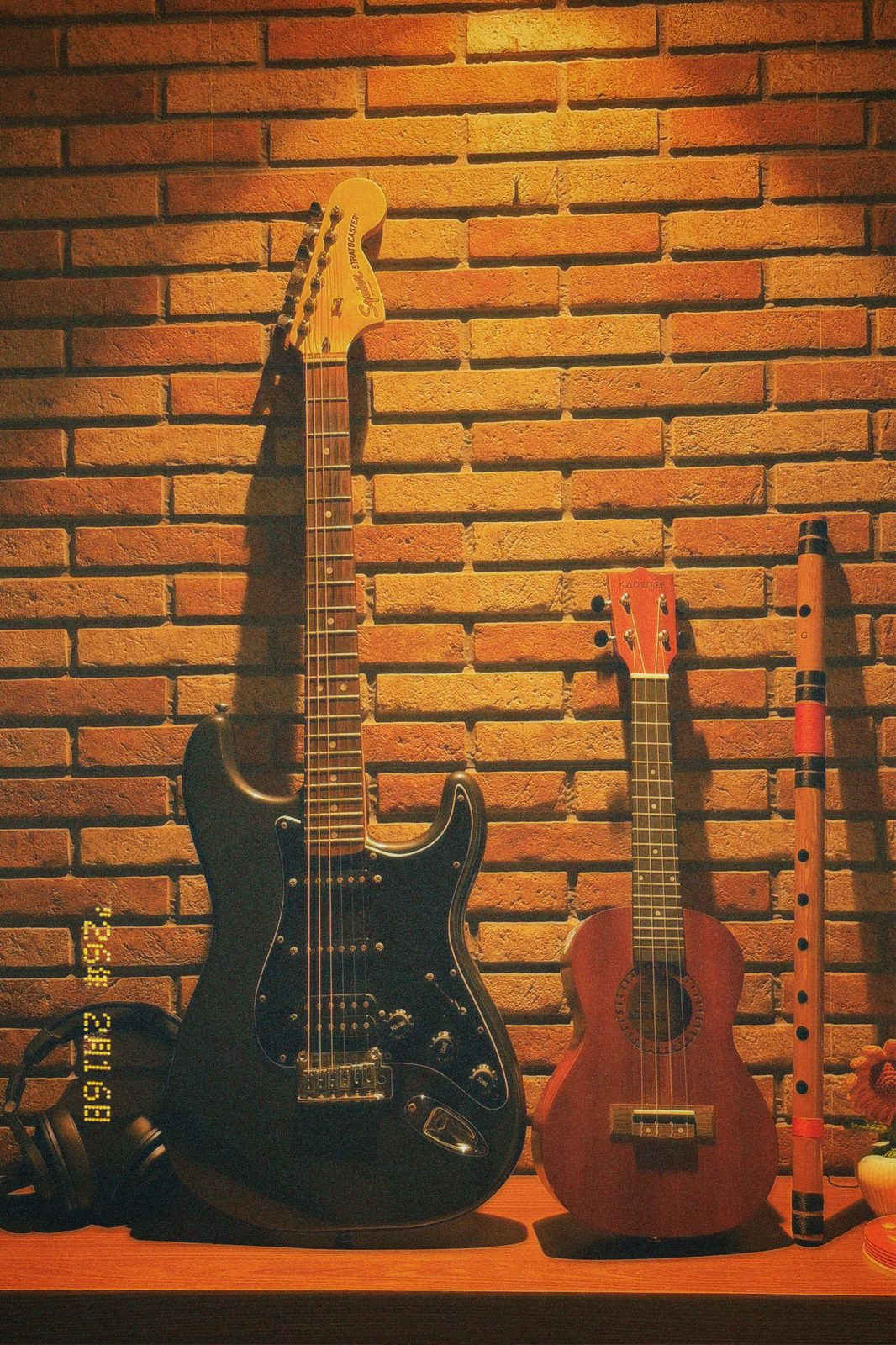 Guitars against a brick wall
